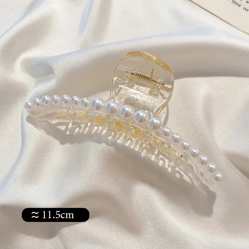 Single pearl bead hair claw clip with clear grip and golden-toned hinge