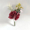 Silk rose boutonniere with burgundy roses, white feather, and yellow flowers