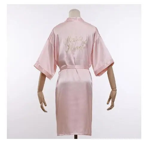 Blush satin robe with embroidered “Maid of Honor” on back and tied waist belt
