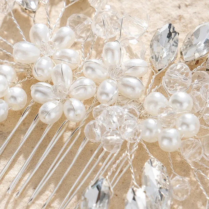 Bridal hair comb detail with white pearls, teardrop crystals, and wire comb tines