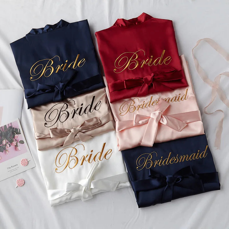 Bride satin robe set in navy, red, blush, and white, each with embroidered Bride