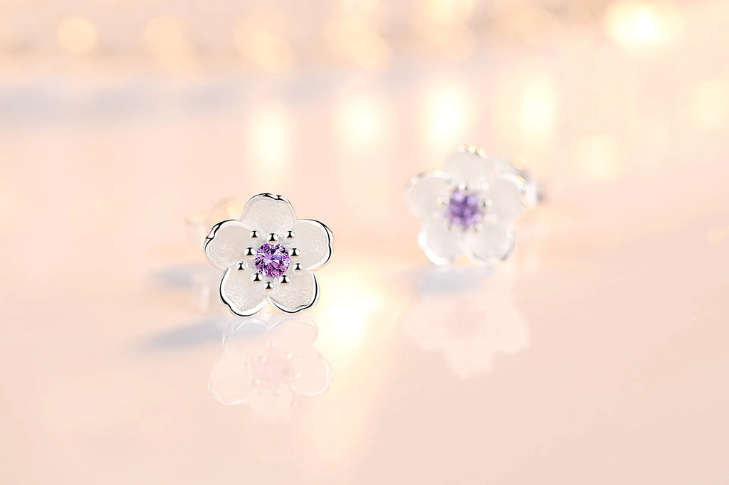 Silver-tone flower stud earrings with purple zircon center and clear outer stones