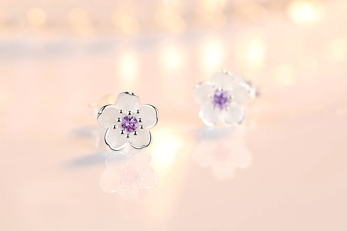 Silver-tone flower stud earrings with purple zircon center and clear outer stones