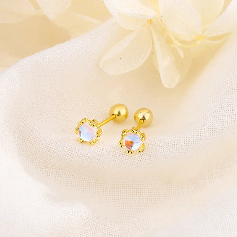 Gold stud earrings with light purple oval stone and tiny clear accents