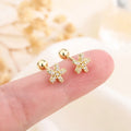 Gold star stud earrings with pink center sparkle stones