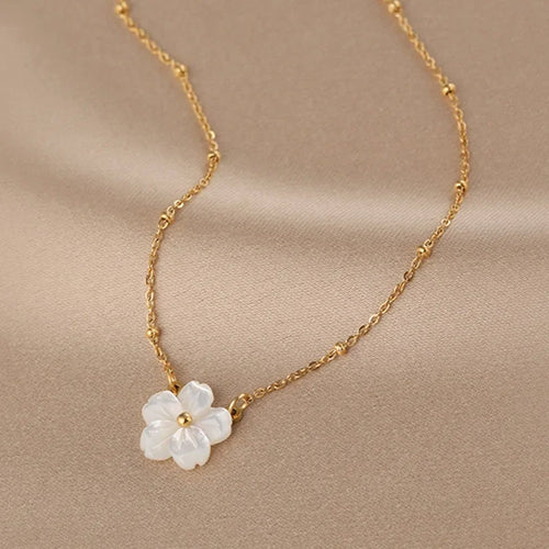 Gold-tone chain necklace with white five-petal pearl flower pendant