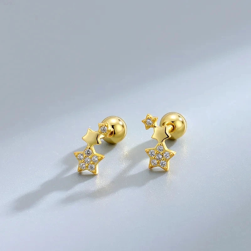 Gold star drop stud earrings with crystal accents, shown as a pair