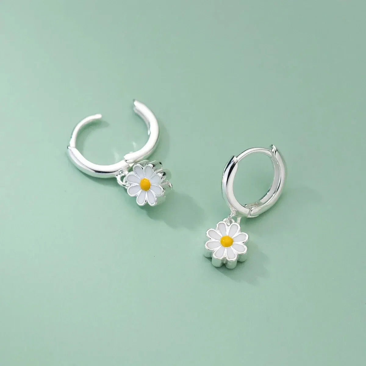 Silver-tone daisy stud earrings with hoop hoops and yellow center flower charm