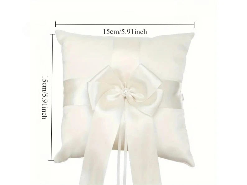 Ivory satin ring bearer pillow with white flower rosette and long ribbon tails