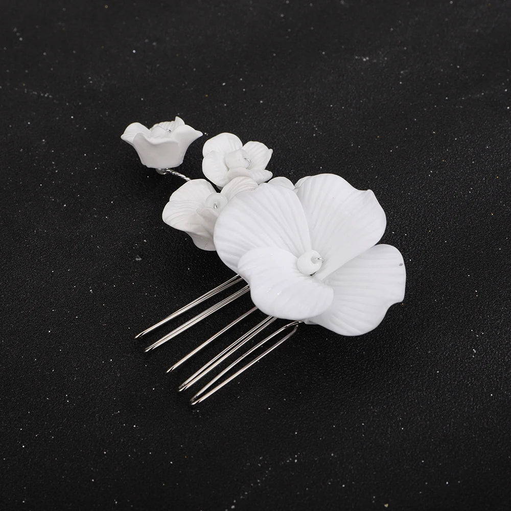 Bridal hair comb with large white orchid and small white blossoms on gold-tone pins