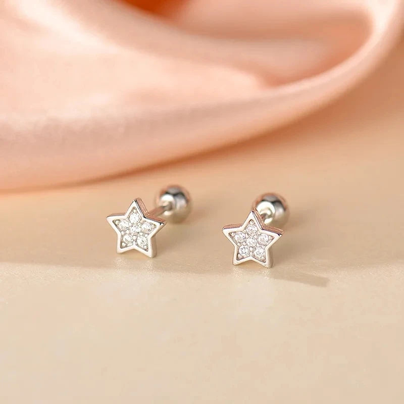 Star huggie hoop earrings with clear crystal accents and silver-tone backs