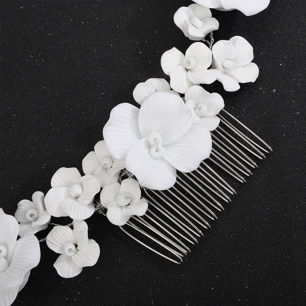 Bridal hair comb detail: oversized white orchid flowers on silver-tone comb prongs