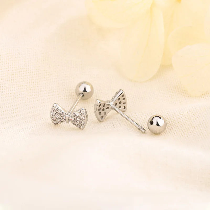 Bow tie huggie hoop earrings with crystal details and silver-tone posts