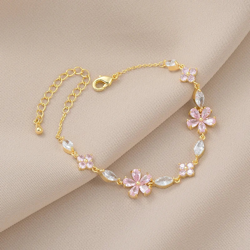 Gold-tone crystal flower bracelet with pink blooms and clear teardrop accents