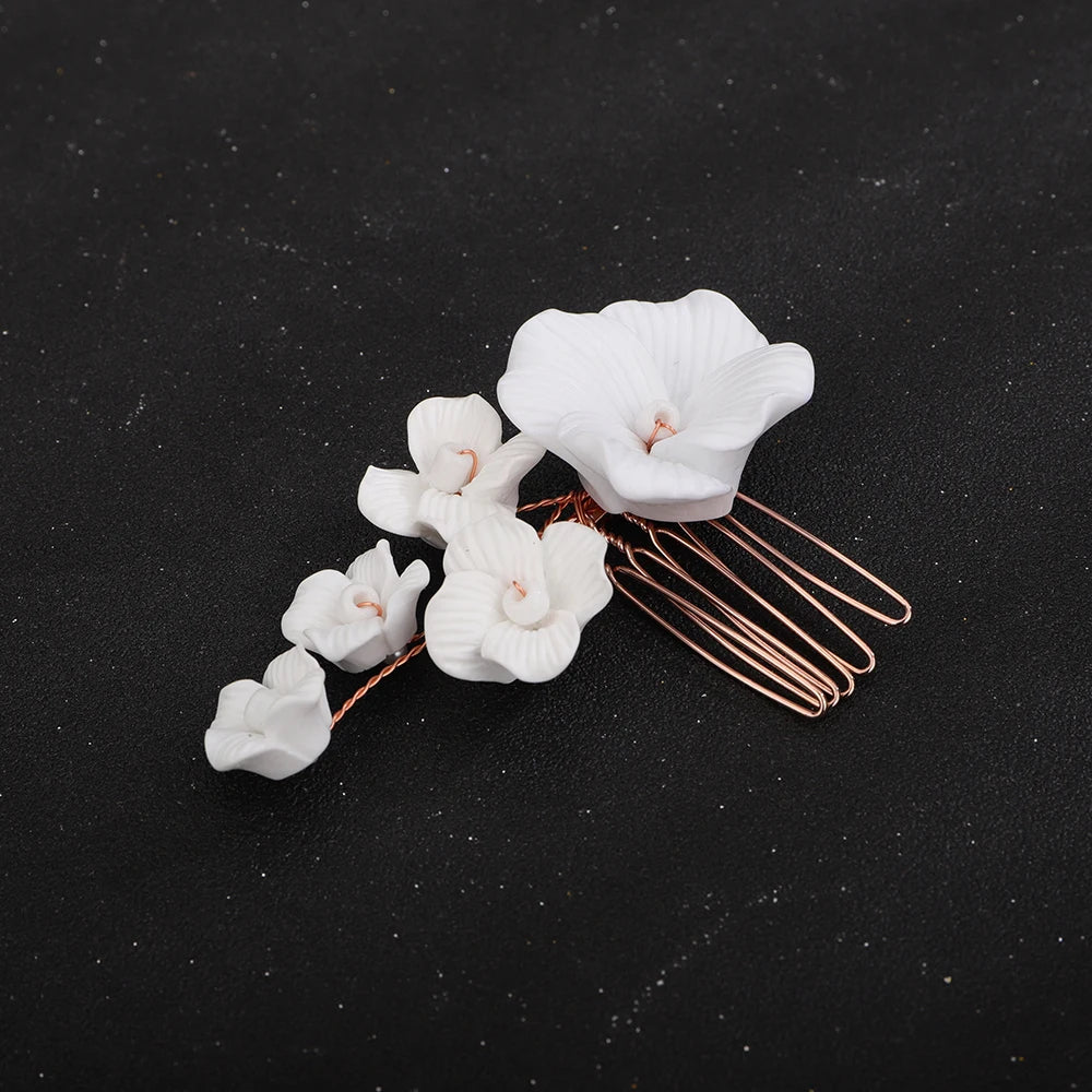 White orchid blossom bridal hair comb with rose-gold prongs and clustered mini flowers