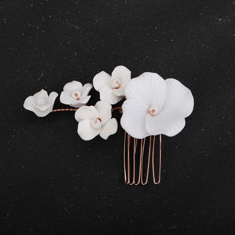 White orchid blossom bridal hair comb with rose-gold prongs and mixed small blossoms