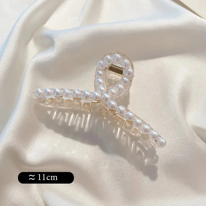 Long pearl bead hair claw clip with clear base, golden-toned hinge, and prongs
