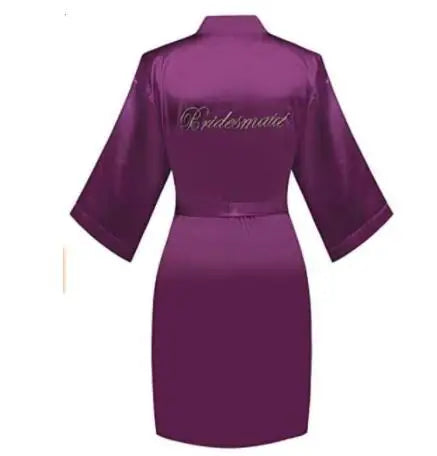 Purple satin robe with embroidered “Bridesmaid” on back and tied waist belt