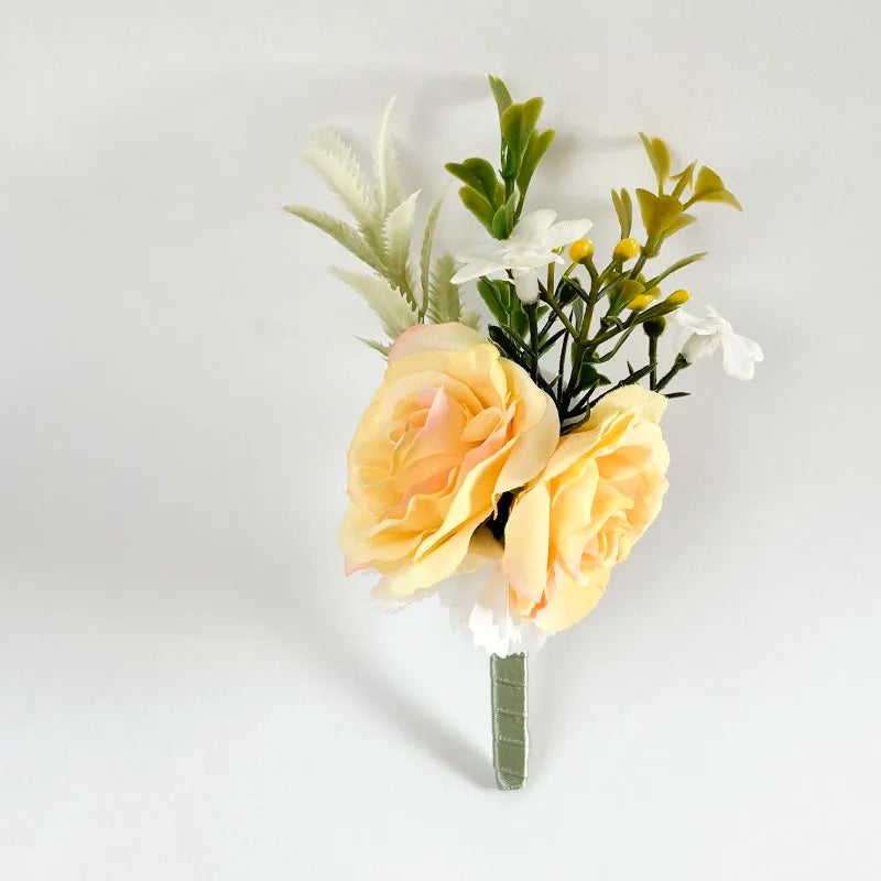 Silk rose boutonniere with two pale yellow roses, white flowers, and green leaves