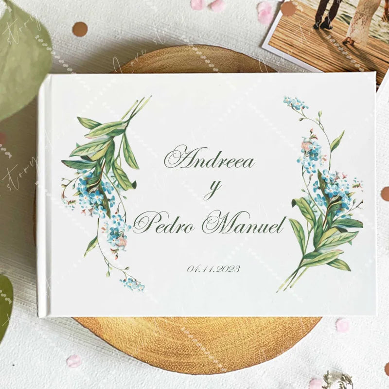 Wedding guest book cover with blue floral sprigs on the corners; names and date 04.11.2023