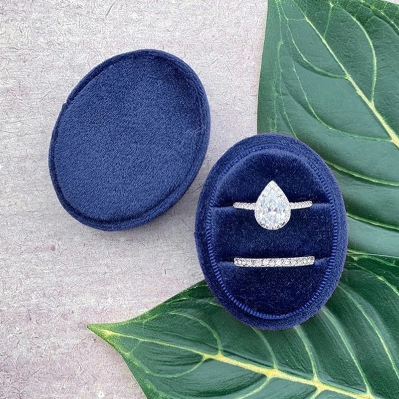 Blue velvet ring box with diamond-style center ring and two bands