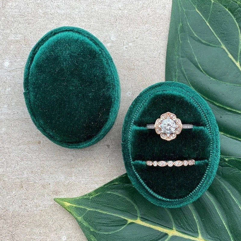 Emerald green velvet ring box with diamond-style ring and slim band