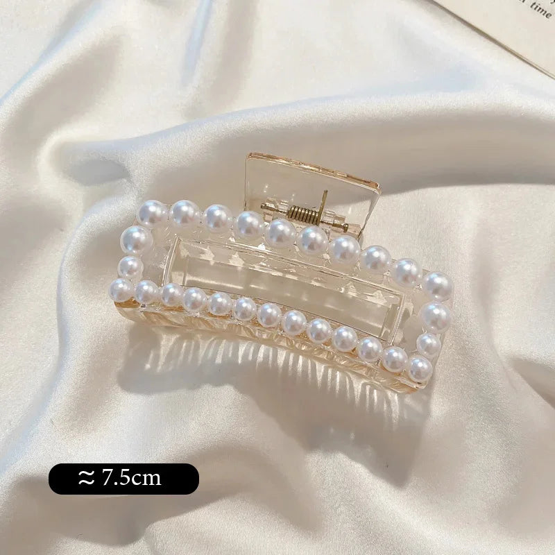 Medium pearl bead hair claw clip with clear base and golden-toned top prongs