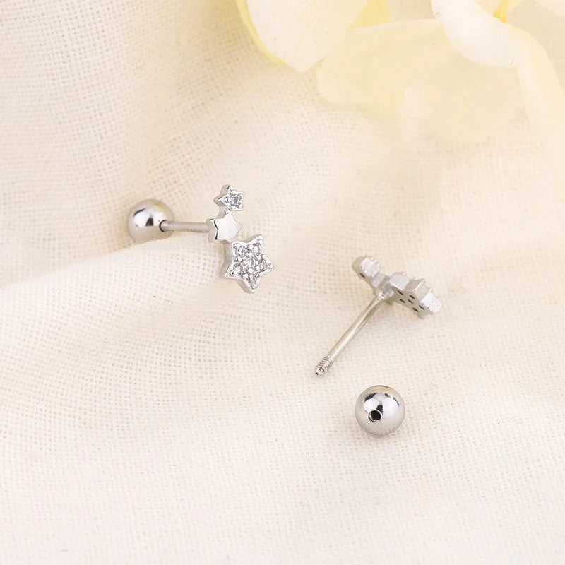 Silver huggie hoop earrings with dangling star crystal charm and round ball post