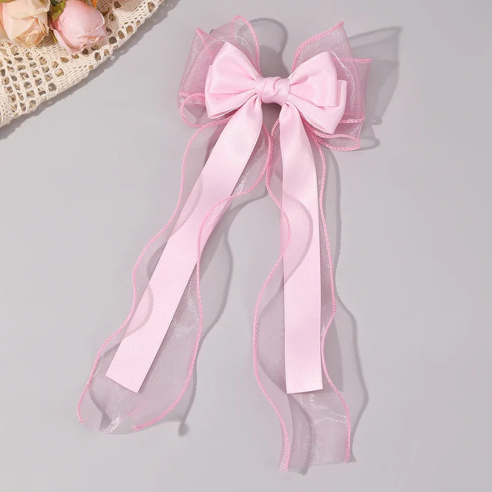 Pink chiffon bow hair clip with long ribbon streamers and layered organza