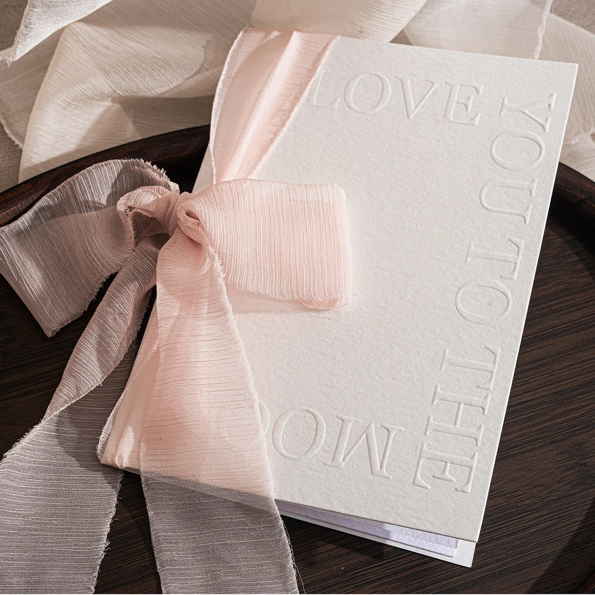 Embossed wedding vow booklet with blush pink organza ribbon bow, 'Love You' and vows