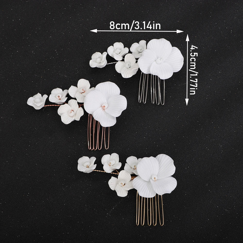 Bridal hair comb set with three clusters of white orchids and gold-tone comb pins