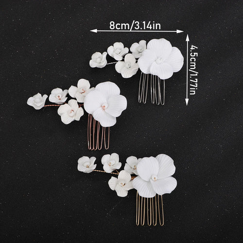 Bridal hair comb set with three clusters of white orchids and gold-tone comb pins