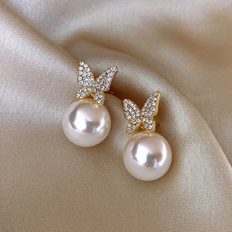 Bow detail pearl stud earrings with crystal accents, round pearls