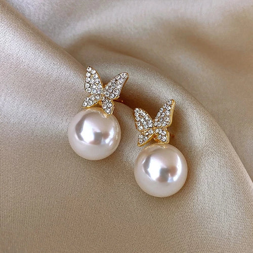 Bow detail pearl stud earrings with crystal accents, round pearls