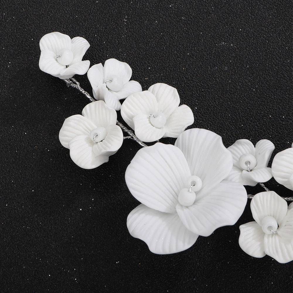 White orchid flower strands on bridal hair comb with silver-tone wire prongs