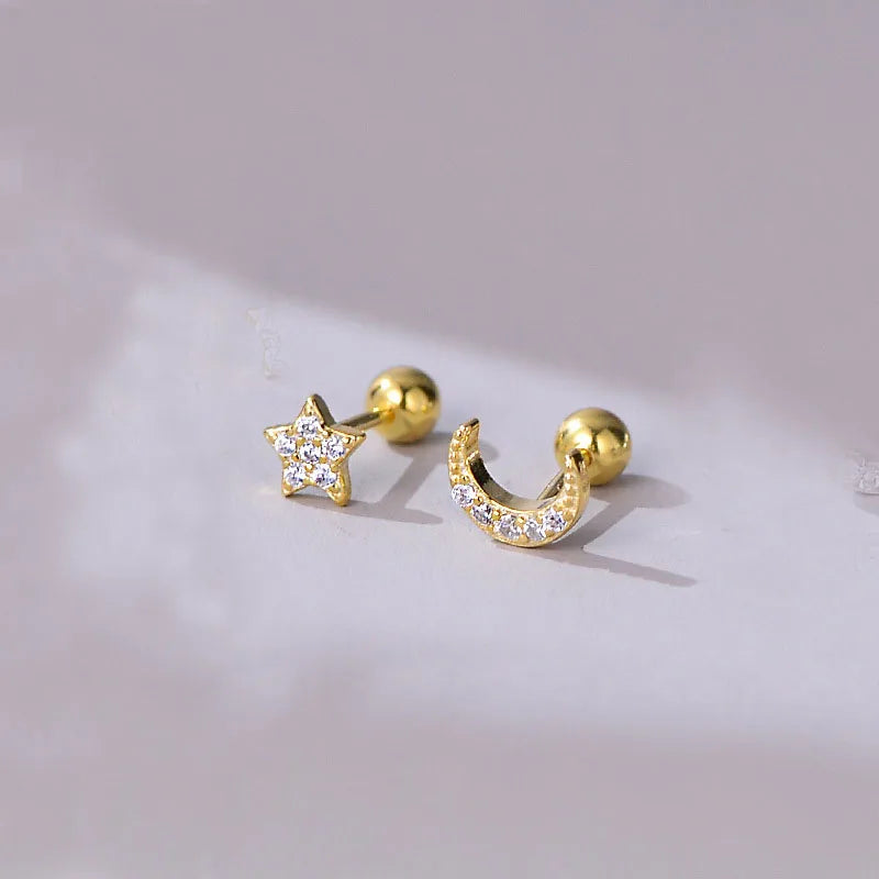 Gold star and crescent stud earrings with clear stones