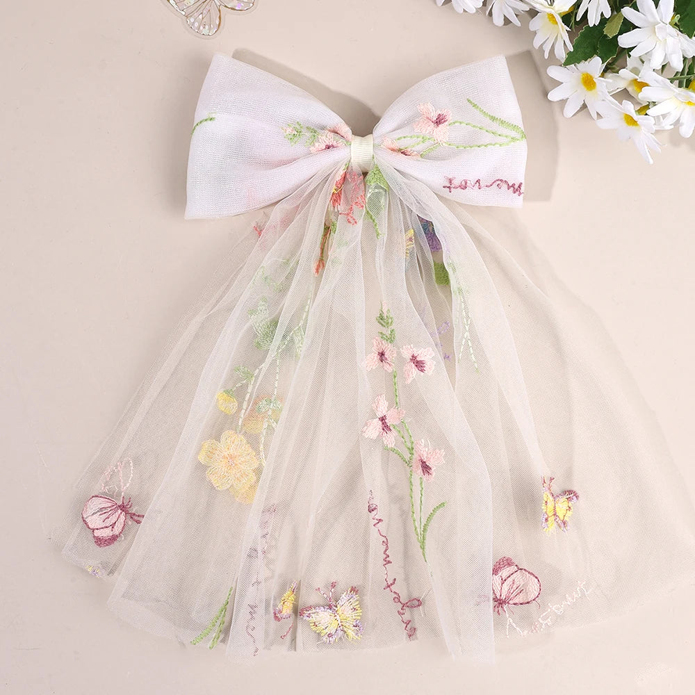 Pastel floral-embroidered tulle bow hair clip with sheer veil