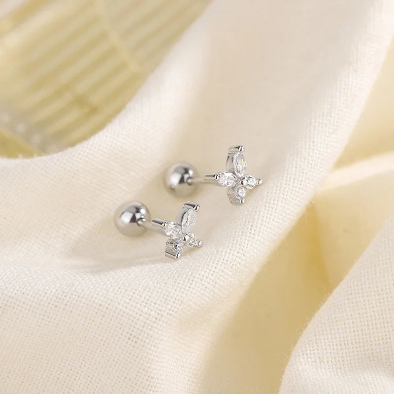 Silver-tone huggie hoop earrings with flower-shaped crystal accents