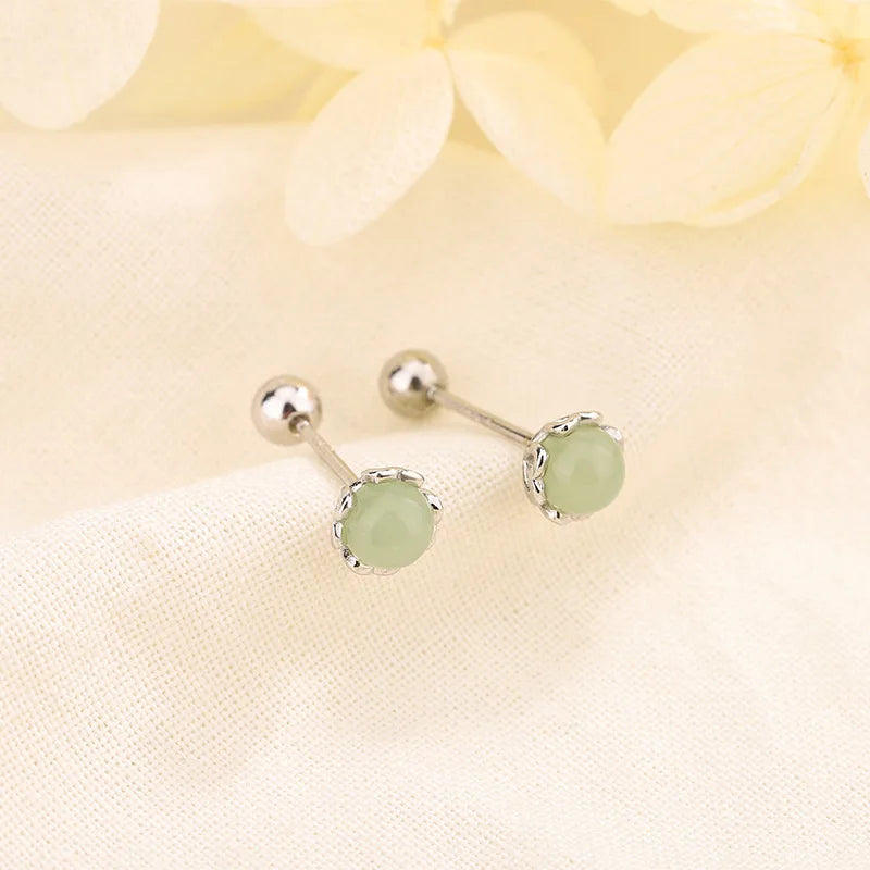 Silver-tone huggie hoop earrings with round green crystal drops