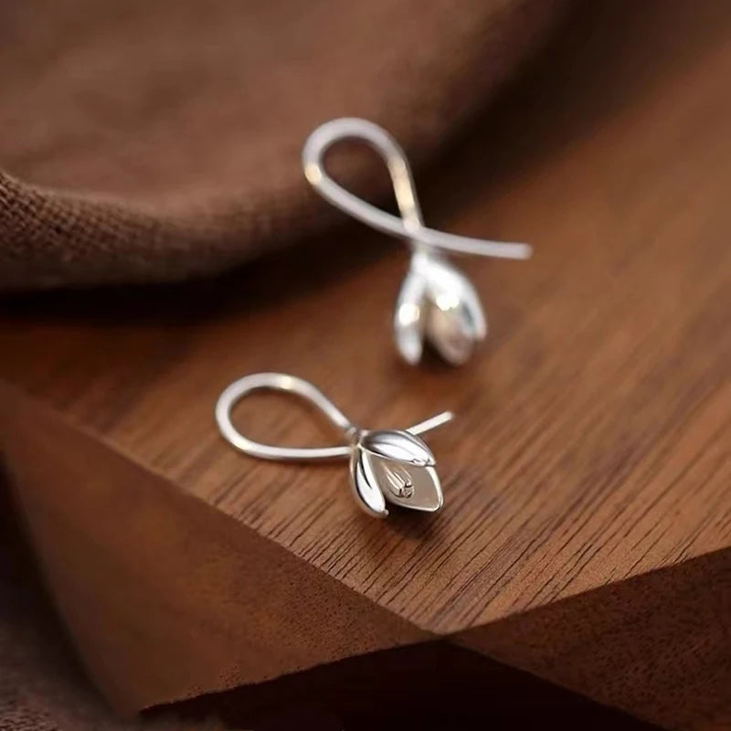 Sterling silver tulip bud wire drop earrings, teardrop hooks with leaf details.
