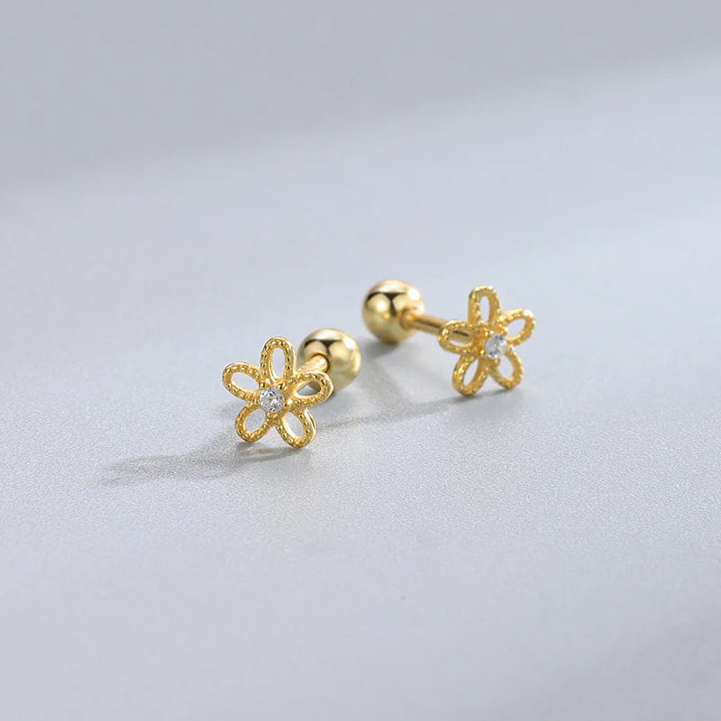 Gold four-petal clover stud earrings with openwork sparkle, ball posts