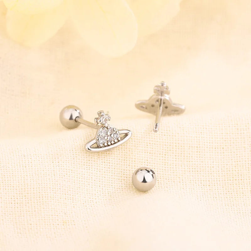 Silver huggie hoop earrings with crystal planet and cross charms and round ball post