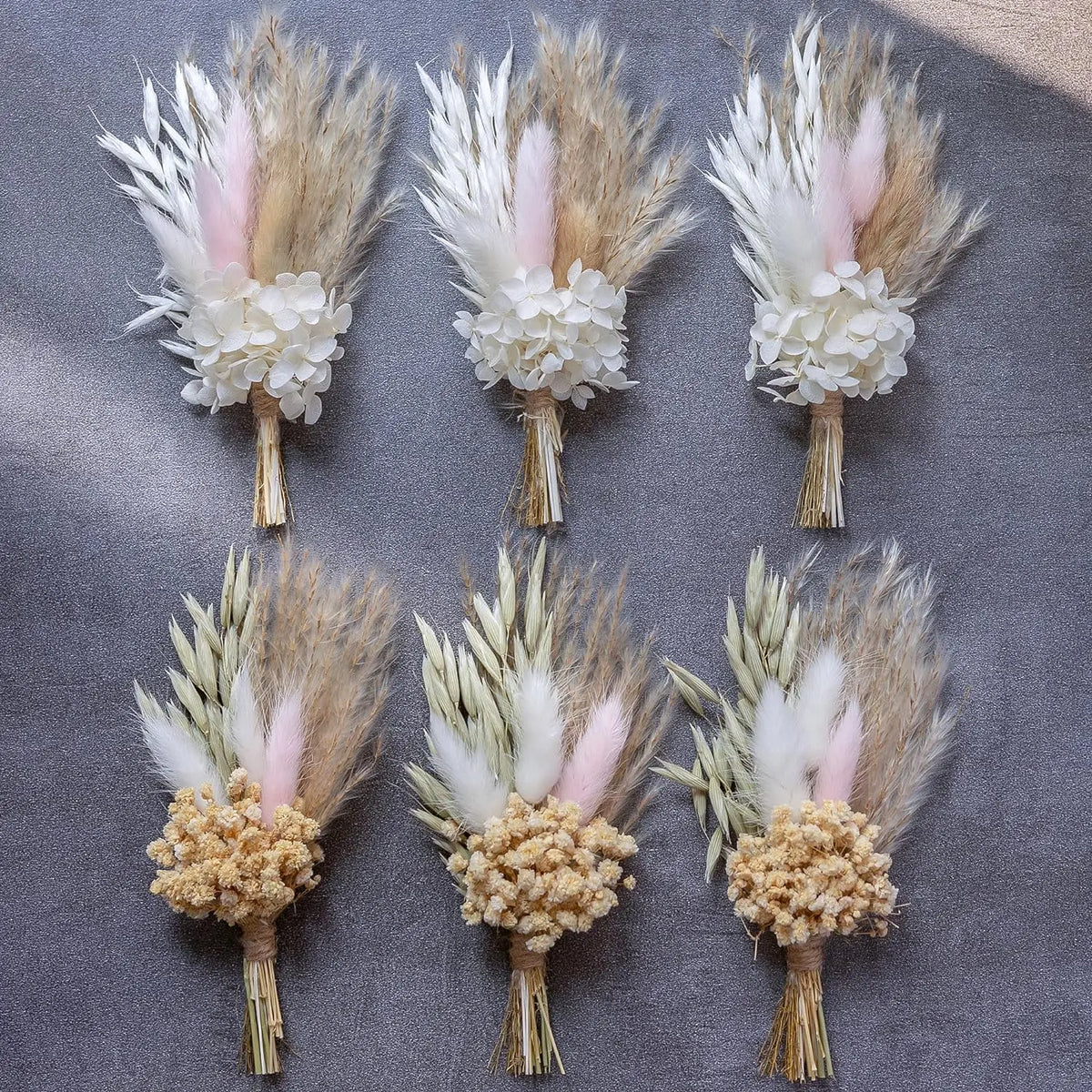 Set of dried flower boutonnieres with white blooms, pale tan pampas, and soft pink tips