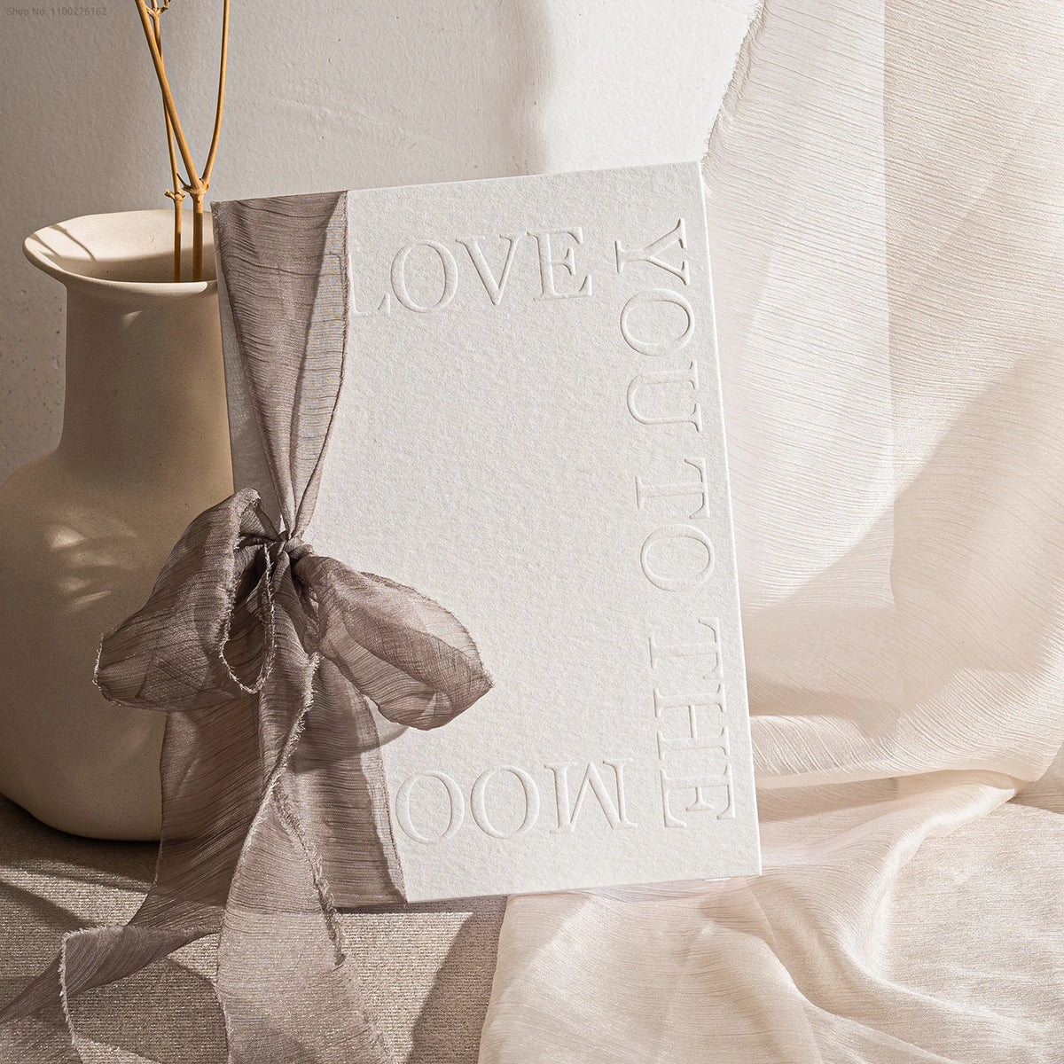 Embossed wedding vow booklet with dark gray organza ribbon bow, 'Love You' and vows