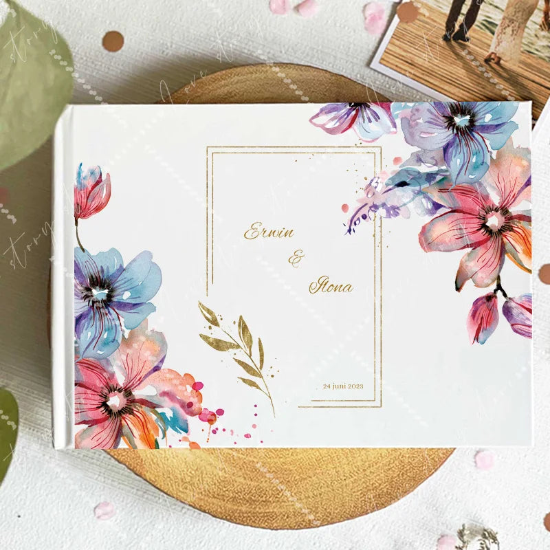 Wedding guest book cover with colorful wildflowers around a center frame; names and date shown