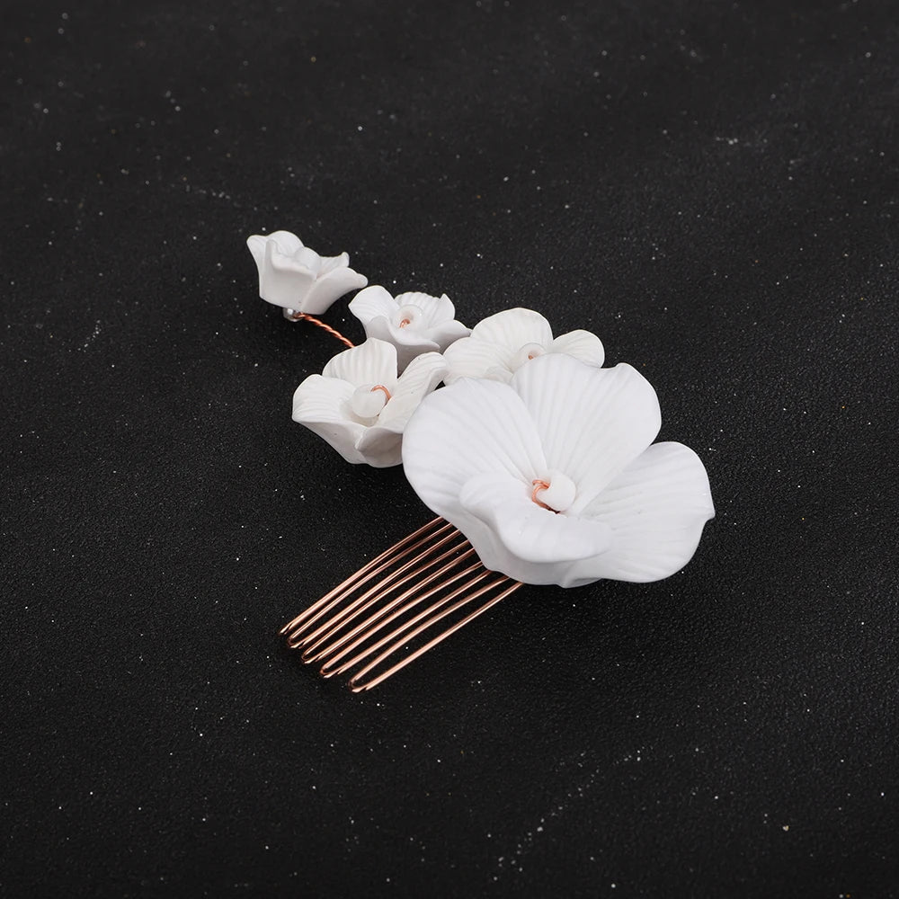 White orchid blossom bridal hair comb with gold-tone prongs and small petal blossoms