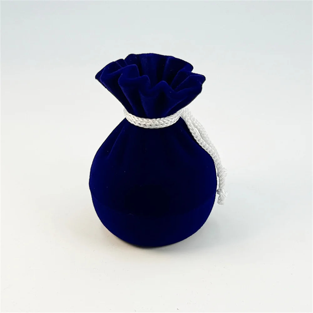 Blue velvet ring pouch with pleated top and drawstring cord.