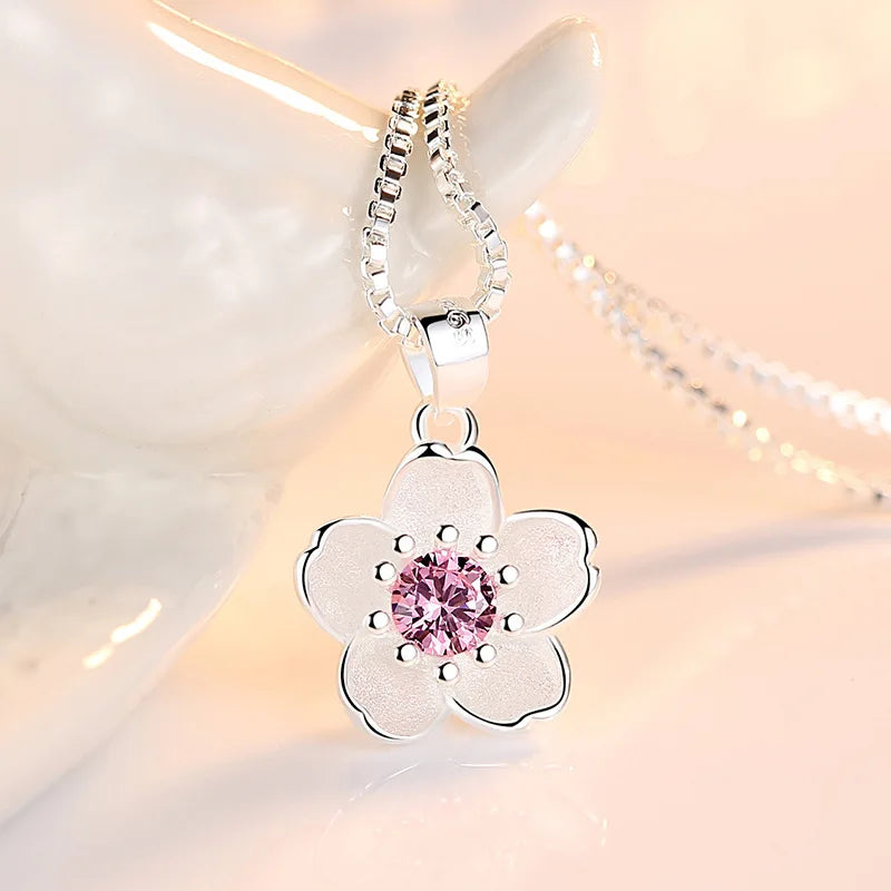 Sterling silver flower pendant necklace with round pink crystal and purple center stone