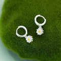 Silver-tone hoop earrings with small daisy charm drop and yellow flower center