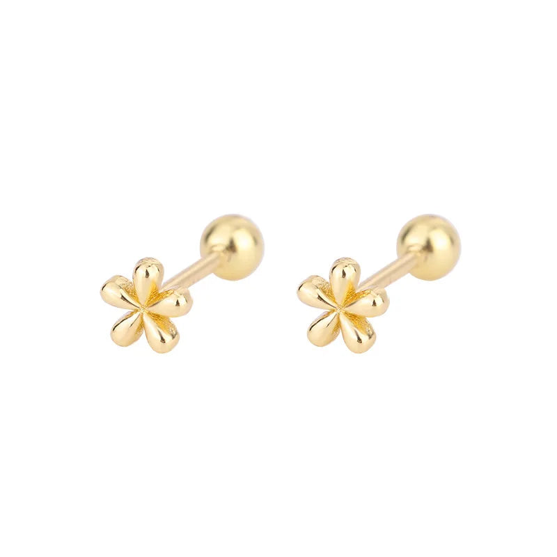 Gold-tone huggie hoop earrings with small flower crystal charms
